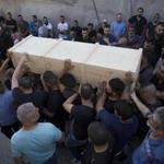 Druze men carry the coffin of Israeli police officer Advanced Staff Sgt. Maj. Hael Sathawi in Mughar, Israel, Friday, July 14, 2017. Arab assailants struck at ground zero of the Israeli-Palestinian conflict on Friday opening fire from inside a major Jerusalem shrine and killing two Israeli policemen. The two slain policemen were members of Israel's Druze community, followers of a secretive off-shoot of Islam. (AP Photo/Ariel Schalit)