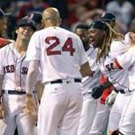 Boston, MA: July 18, 2017: Red Sox 1B Hanley Ramirez (second fromright) won the game for Boston with a bottom of the 15th inning walk off solo home run, that brought his temmates to the plate to greet him. The Boston Red Sox hosted the Toronto Blue Jays in a regular season MLB baseball game at Fenway Park. (Jim Davis/Globe Staff)