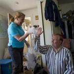 Martha A. Shea, program coordinator of ClearPath, helped Don Gage sort through his cluttered home. 