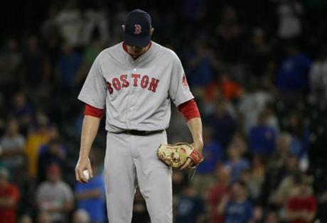 Red Sox reliever Doug Fister was frustrated after the Mariners scored the game-tying run on a wild pitch.
