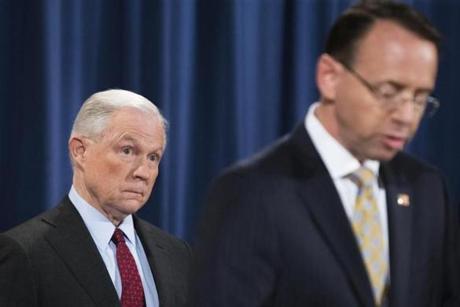 Attorney General Jeff Sessions looks on as Deputy Attorney General Rod Rosenstein gives a statement at the Department of Justice in Washington on July 20.
