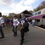 Patriots fans exited a train at the Gillette Stadium stop, which sees service on game days. Plans to run daily service from Foxborough to Boston via the Fairmount Line have drawn criticism.