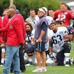 Foxborough -07/29/2017- The Patriots held their third day of training camp at the practice field of Gillette Stadium. Patriot Hall of Famers came to the field at the end of practice, as the players huddled around them Kevin Faulk(left) was introduced by coach Bill Belichick. John Tlumacki/Globe staff(sports)
