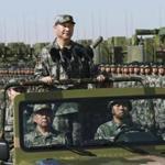 In this photo released by Xinhua News Agency, Chinese President Xi Jinping stands on a military jeep as he inspects troops of the People's Liberation Army during a military parade to commemorate the 90th anniversary of the founding of the PLA at Zhurihe training base in north China's Inner Mongolia Autonomous Region, Sunday, July 30, 2017. China's military has the 