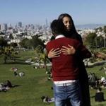 In this July 14, 2017 photo, Julie Rajagopal, facing, hugs her 16-year-old foster child from Eritrea after posing for photos at Dolores Park in San Francisco. When he landed in March, he was among the last refugee foster children to make it into the U.S. Trump administration travel bans declared to block terrorists also are halting a small, three-decade-old program bringing orphan refugee children to waiting foster families in the United States. (AP Photo/Jeff Chiu)