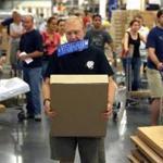 A shopper carried a box and an order slip in his mouth as he made his way through a mob of shoppers during a sales tax holiday in 2007. 