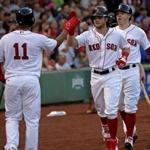 Boston, MA - 8/05/2017 - (1st inning) Boston Red Sox left fielder Andrew Benintendi (16) is congratulated by Boston Red Sox third baseman Rafael Devers (11) after his two run home run in the first inning. The Boston Red Sox host the Chicago White Sox at Fenway Park. - (Barry Chin/Globe Staff), Section: Sports, Reporter: Peter Abraham, Topic: 06Red Sox-White Sox, LOID: 8.3.3282099613.