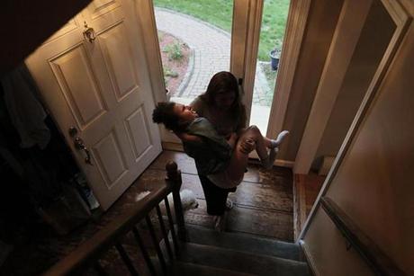 Dracut, Ma., 06/08/17, It's been over 100 days since Noelia has had skilled nursing help. She carries her 78-pound daughter up the stairs to begin the evening's bed-time rituals. Suzanne Kreiter/Globe Staff
