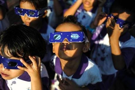 Malaysian school children wore glasses with special filters watch the partial solar esclipse at the National Planetarium in Kuala Lumpur in 2016.
