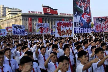 Tens of thousands of North Koreans gathered for a rally at Kim Il Sung Square carrying placards and propaganda slogans as a show of support for their rejection of the United Nations' latest round of sanctions on Wednesday Aug. 9, 2017, in Pyongyang, North Korea. (AP Photo/Jon Chol Jin)
