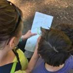 The author and her two sons consult a map while on vacation in California. 