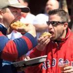4/8/2013 - Boston, MA - Fenway Park - Matt McClelland, cq, of Warwick, RI, left; and Keith Couto, cq, of Rumford, RI; dig in to Kayem Italian sausages before the game. They've been season ticket holders for 14 years and the sausages are a tradition. 