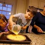 Eloise and Pierce Brault help their mother, Caitlin McCormick-Brault, make quiche.