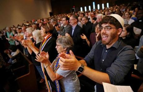 Boston, MA- August 18, 2017: Bryan Mann, a rabbinical school student, applauds comments from Attorney General Maura Healey during the Interfaith Gathering of Unity, Love, and Strength at Temple Israel of Boston in Boston, MA on August 18, 2017. Organized by the Greater Boston Interfaith Organization, the gathering offered an opportunity to come together and send a message of unity and diversity in the face of hate. Thousands of protesters are expected to flood downtown Boston Saturday, with a pro-free speech rally on Boston Common likely surrounded by several different counter-actions. (CRAIG F. WALKER/GLOBE STAFF) section: metro reporter: 
