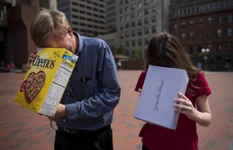 ECLIPSE SLIDE5 Boston, MA - 8/21/17 - Mike Wilson, left, and his daughter Stephanie, check out the partial solar eclipse in City Hall Plaza on Monday, August 21, 2017. (Nicholas Pfosi for The Boston Globe) Topic: 22eclipsepic
