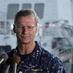 Vice Admiral Joseph Aucoin, Commander of the US 7th Fleet, looks on during a press conference as the damaged US Navy destroyer USS Fitzgerald is seen in the background at Yokosuka Naval Base in Yokosuka, south of Tokyo, in June.