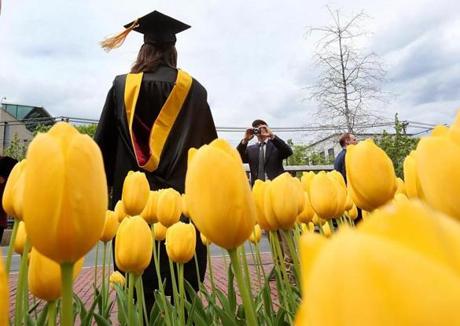  Boston, MA., 05/03/17, At Northeastern University, Ann Farr, cq, gets photographed in front of blooming tulips as she celebrates her graduation and her Masters degree in Science and Nursing. Globe staff/Suzanne Kreiter
