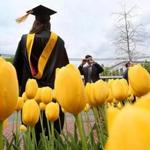  Boston, MA., 05/03/17, At Northeastern University, Ann Farr, cq, gets photographed in front of blooming tulips as she celebrates her graduation and her Masters degree in Science and Nursing. Globe staff/Suzanne Kreiter
