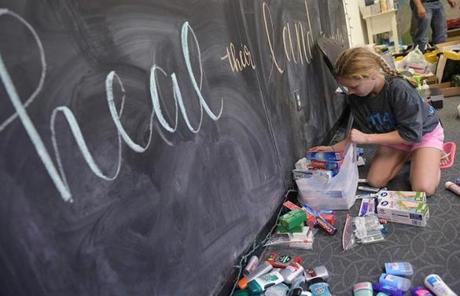 A girl sorts toiletries at a shelter for volunteer rescue workers set up at the Fairfield Baptist Church student building on August 29, 2017 in Cypress, Texas. The shelter was set up as a place to rest for volunteer rescue workers who had come to the Houston area in the aftermath of Hurricane Harvey. Harvey has set what forecasters believe is a new rainfall record for the continental US, officials said Tuesday. Harvey, swirling for the past few days off Texas and Louisiana has dumped more than 49 inches (124.5 centimeters) of rain on the region. / AFP PHOTO / MANDEL NGANMANDEL NGAN/AFP/Getty Images
