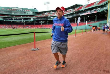 Boston-07/15/2017-Dave McGillivray runs along the warning track of Fenway Park as he checked out the course for a September 15th 2017 marathon fundraiser to be held inside the ballpark. It will be the first time a marathon will be held inside a major league ball field. He has dozens of runners already signed up for the event. John Tlumacki/Globe Staff(sports)

