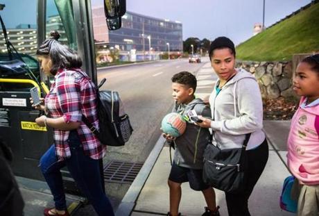 Ivelisse Florentino boarded a bus with her three children outside their temporary housing at the Home Suites Inn in Waltham. From left are emily Familia, 16, Daniel Santana, 9, and Daniela Santana, 10.
