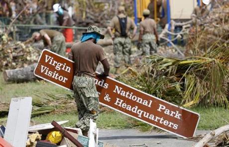 STJOHN SLIDER Cruz Bay, St. John -- 9/13/2017 - A member of the Navy clears away a sign that was knocked down in Hurricane Irma as cleanup gets underway in St. John. (Jessica Rinaldi/Globe Staff) Topic: Reporter: 

