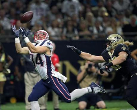 New Orleans, LA: September 17, 2017: Patriots RB Rex Burkhead (left) leaves Saints LB Alex Anzalone in the dust as he hauls in a first quarter touchdown pass from Tom Brady that put New England ahead 6-0. The New England Patriots visited the New Orleans Saints in a regular season NFL football game at the Mercedes-Benz Superdome. (Jim Davis/Globe Staff). 
