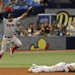 Boston Red Sox's Xander Bogaerts, left, and Rafael Devers cannot stop a ground ball single hit by Tampa Bay Rays' Evan Longoria that drove in Jesus Sucre from third base during the fifth inning of a baseball game Sunday, Sept. 17, 2017, in St. Petersburg, Fla. (AP Photo/Steve Nesius)