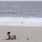A beachgoer sat in a chair in New Jersey as waves crashed and Jose churned offshore.