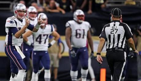 Tom Brady signals to the official that the New Orleans Saints had 12 players on the field.
