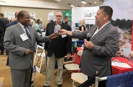  A lucky recipient (left) receives a $300 cash giveaway inside the exhibitors hall at the Cape Cod Symposium on Addictive Disorders, Friday, September 15, 2017. ( CREDIT: Evan Allen/Globe Staff)

