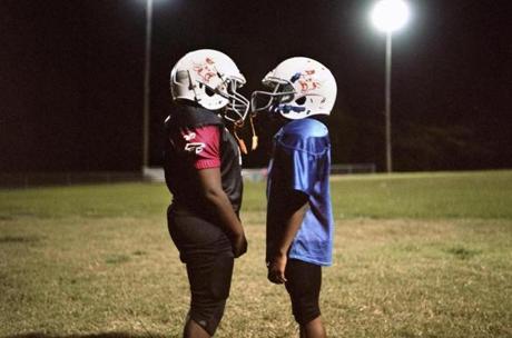 Marshall Longhorns football players during a break from practice in Marshall, Texas, Oct. 20, 2016. Tackle football is making a comeback among Marshall youths, despite the well-known safety risks associated with playing at such a young age. (Brandon Thibodeaux/The New York Times)

