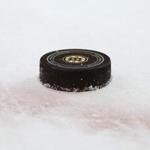 A Boston Bruins official game puck sits on the ice during the third period of the Bruins 4-2 win over the Chicago Blackhawks in an NHL preseason hockey game in Boston, Monday, Sept. 25, 2017. (AP Photo/Winslow Townson)