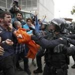 Catalonians clashed with police outside a polling center in Girona, Spain.