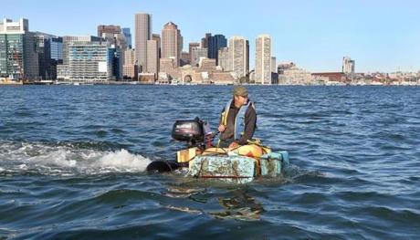 Boston, MA - 10/1/2017 - Taking off from Jeffries Yacht Club (cq), in East Boston, Christian Ilsley (cq) pilots his pumpkin boat around Boston Harbor for about an hour Sunday morning. It was built from his giant pumpkin, scrap wood, 100 ft. of rope, 44 screws, yacht bumper, dock foam and powered by a Suzuki Four Stroke 4HP motor. Rob Cortes (cq), his engineer, said it took 