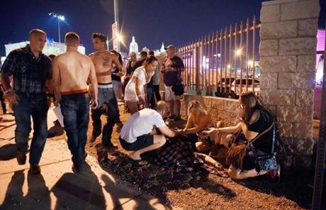 LAS VEGAS SLIDER2 LAS VEGAS, NV - OCTOBER 01: People tend to the wounded outside the festival ground after an apparent shooting on October 1, 2017 in Las Vegas, Nevada. There are reports of an active shooter around the Mandalay Bay Resort and Casino. (Photo by David Becker/Getty Images)
