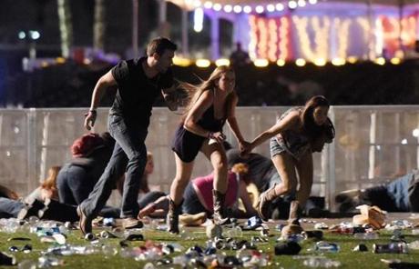 LAS VEGAS, NV - OCTOBER 01: People run from the Route 91 Harvest country music festival after apparent gun fire was hear on October 1, 2017 in Las Vegas, Nevada. A gunman has opened fire on a music festival in Las Vegas, leaving at least 20 people dead and more than 100 injured. Police have confirmed that one suspect has been shot. The investigation is ongoing. (Photo by David Becker/Getty Images)
