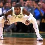 Boston, MA: October 2, 2017: The Celtics Kyrie Irving gets down low as he waits for the opening tap off to his first game in a Boston uniform. The Boston Celtics hosted the Charlotte Hornets in a pre season NBA basketball game at the TD Garden. (Jim Davis/Globe Staff).