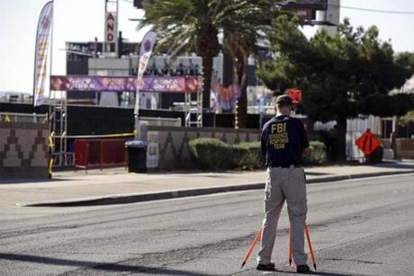 An FBI agent examined the shooting scene on Tuesday.
