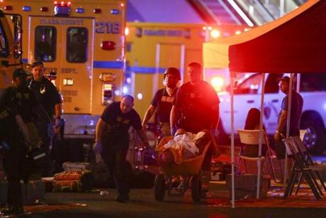 A wounded person was transported by a wheelbarrow in the wake of the shooting.
