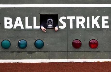 Boston Ma?April 5, 2017-Stan Grossfeld/Globe Staff- A scorekeeper takes a peek through the remote camera installed in the Green Monster, giving the unblinking eye a touch of humanity. ?Do Not Bump? it says on the camera mount.
