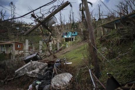 Homes and infrastructure lie in ruins outside the city of Caguas, Puerto Rico, on Tuesday. 
