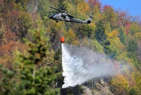 A black hawk helicopter dumped 600 gallons of water near the peak of the 600-foot high ridge.
