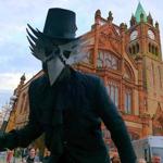 A crow?figure on stilts in Guildhall Square.