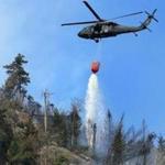 A black hawk helicopter dumped water onto a fire burning in the White Mountains.