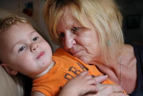 Susan Anderson Lopes and her 2-year-old grandson, Mason Anderson, at their home in Bourne.
