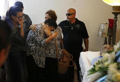 NOTE -- David Dahl has apporved this image to run --- Corozal, Puerto Rico -- 10/02/2017 - Ana Ruiz is consoled by a loved one as funeral directors prepare to close her husband, Victor Ruiz Ramos' casket. (Jessica Rinaldi/Globe Staff) Topic: Reporter: 
