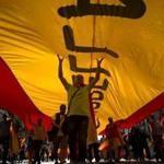 Protesters held a giant Spanish flag during a demonstration Sunday to oppose the Catalonia independence movement. 
