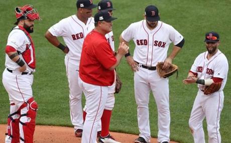 BOSTON, MA 10/08/2017 Red Sox manager John Farrell (center) pulls starting pitcher Doug Fister (right of Farrell) in the second inning. The Boston Red Sox host the Houston Astros in Game Three of the ALDS at Fenway Park in Boston on Oct. 8, 2017. (Stan Grossfeld/Globe Staff) 
