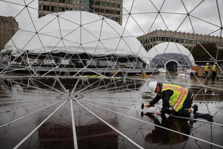 Tomasz Cichy worked on installing one of six geodesic domes Monday on City Hall Plaza for HUBweek, which opens today.
Project manager Sam Carson passed through one of six geodesic domes being constructed at City Hall Plaza.
